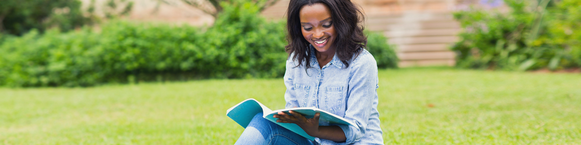african female college student reading book